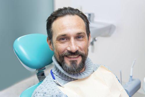 A elderly man smiling after getting tooth filings in Columbia, Md